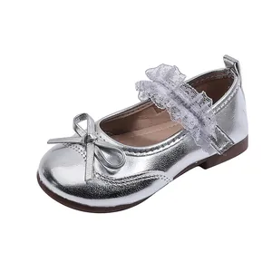 Silver metallic Mary Jane shoes for girls with bow and lace strap on white background