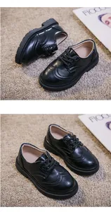 Detail showing classic brogue carving and lace-up design on black children's leather shoes