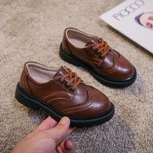 Brown British style brogue shoes for kids with soft thick soles and carved detailing