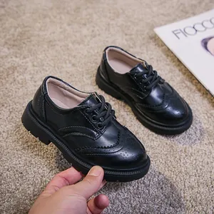 Classic black kids Brogue shoes with polished leather and lace-up design for formal wear