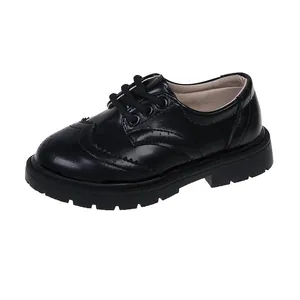 Classic black Brogue leather shoes for kids with carved details and thick rubber lug sole