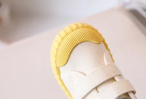 Detailed macro view of the rubber toe cap and canvas texture on kids' shoes