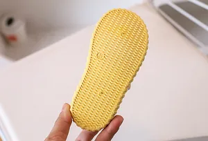 Detail of yellow anti-slip rubber sole with size 24 marking and diagonal traction patterns