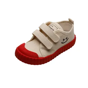 Kids canvas sneakers with red rubber soles and smiley face print for casual wear
