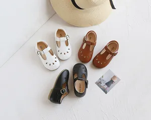 Detail of vintage girls Mary Jane shoes with hollow cut-outs and T-strap buckles