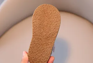 Close-up of flexible rubber sole with non-slip texture and size 23 mark on girls shoes