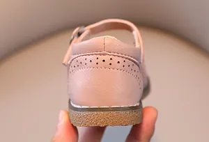 Close-up of pink girls' Mary Jane shoes featuring hollow carved heel and non-slip rubber sole