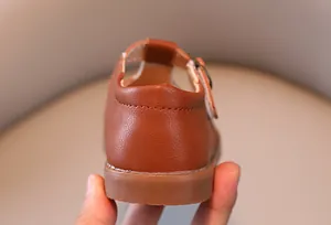 Détail de chaussures Mary Jane marron montrant la couture et la semelle en caoutchouc