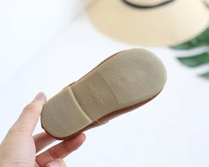 Detail of baby shoe rubber sole with anti-slip texture and size 23 brand engraving