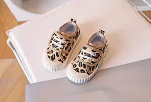 Detailed view of baby canvas shoes with leopard print and convenient velcro strap
