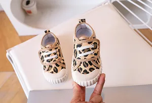 Detailed view of leopard print canvas kids shoe with velcro strap and rubber toe cap