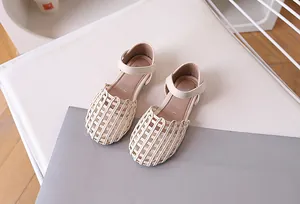 Detail of woven cutout toe and cream white leather on girls summer princess sandals
