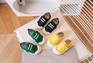 Toddler canvas shoes in black, green and yellow with rubber soles and velcro straps