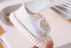 Detail of baby canvas shoes showing breathable fabric and non-slip rubber toe cap