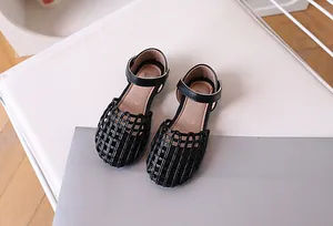 Detailed top view of black woven girls' sandals featuring soft pink cushioned insoles