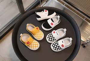 Detail of children's checkered canvas shoes with hook-and-loop closure in various colors