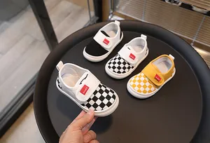 Detail view of checkered kids canvas sneakers with convenient velcro straps for toddlers