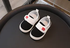 Detailed view of kids' canvas shoes with hook-and-loop straps and anti-slip rubber soles
