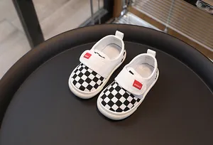 Close-up of kids checkered canvas shoes with hook-and-loop closure and non-slip sole
