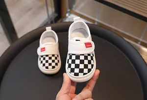Macro shot of children's checkered canvas shoes with non-slip white rubber soles