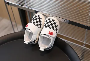 Close-up of children's canvas sneakers with checkerboard pattern and velcro strap detail