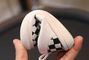 Detail showing high flexibility of the black and white checkered canvas shoe sole