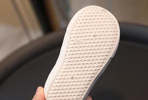 Detail of white rubber sole for children canvas shoes featuring anti-slip triangle patterns