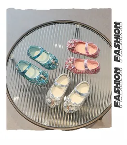 Detail of girls princess shoes with glitter texture, rhinestone bows, and Mary Jane straps