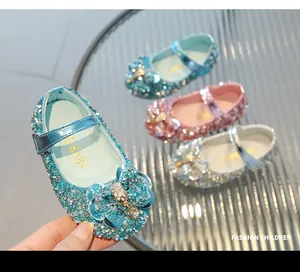 Detail of girls' sequin Mary Jane shoes with rhinestone bows in blue, pink and silver