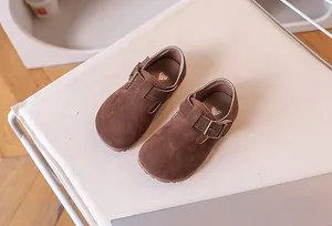 Détail de chaussures Mary Jane en daim marron pour enfants avec boucle et motif de cœur