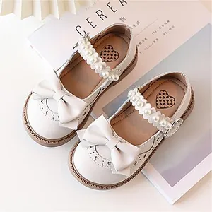 Elegant white girls' Mary Jane shoes with pearls, bow details, and heart cut-outs