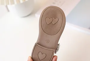 Detail of non-slip rubber sole for children shoes with heart patterns and size marking