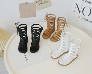 Detail of high-top gladiator sandals for girls in black, khaki and white colors