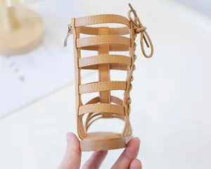 Detail of camel girls Roman gladiator sandals with back bow and side zipper closure
