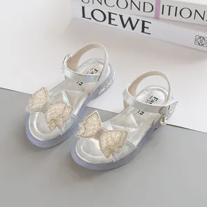 Silver girls sandals with pearl bow and iridescent finish on translucent purple sole
