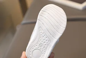 Gros plan d'une semelle de chaussure bébé avec motif antidérapant et marquage taille 20