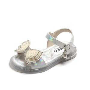 Iridescent silver girls sandals with pearl bow and ankle strap on white background