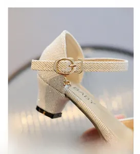 Detail of glitter girls' princess sandal featuring metal buckle strap and low square heel
