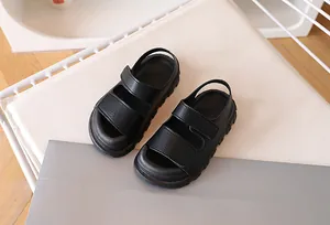 Detail view of black kids' sandals featuring dual hook-and-loop straps and textured non-slip sole