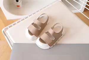 Close-up of khaki children's sandals with non-slip thick soles and adjustable velcro straps