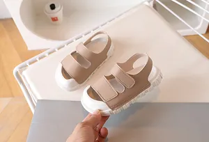 Detailed view of children's beige sports sandals with velcro straps and anti-slip thick soles