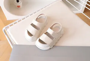 Close-up of cream children's sandals featuring adjustable straps and anti-slip thick soles