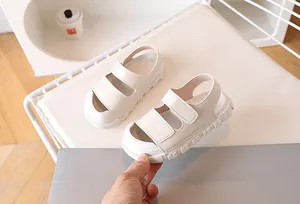 Detail of cream children's sandals with double straps, thick anti-slip sole and velcro closure
