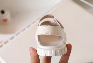 Detail of soft synthetic leather texture and anti-slip thick sole on kids sandals