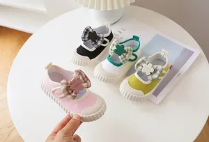 Flat lay of colorful children Mary Jane canvas shoes with bow tie and Velcro straps