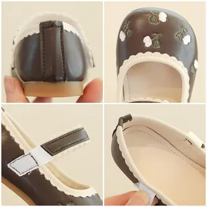 Brown Mary Jane shoes for girls featuring floral embroidery and wave edges