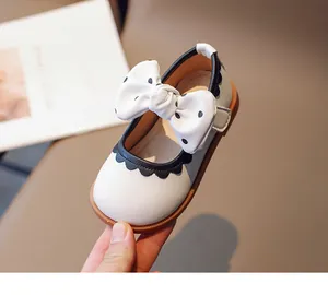 Detail von Baby-Mary-Jane-Schuhen mit weißer Polka-Dot-Schleife und Wellenrand