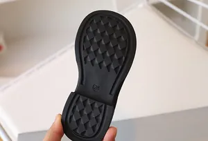 Detailed view of children's shoe anti-slip rubber outsole with size 26 marking