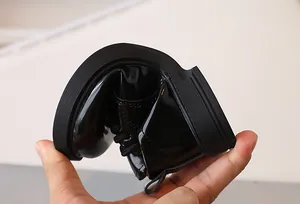Close-up of flexible black patent leather kids shoes being bent to show soft soles
