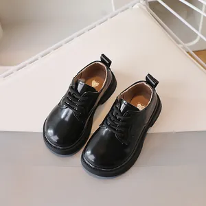 Classic black patent leather kids shoes with lace-up design and thick soles